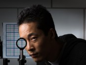 University of Rochester PhD student Joseph Choi demonstrates his `cloaking' device using just four lenses. Credit: Adam Fenster / University of Rochester