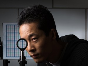 University of Rochester PhD student Joseph Choi demonstrates his `cloaking' device using just four lenses. Credit: Adam Fenster / University of Rochester