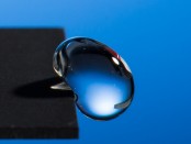 Professor Chunlei Guo has developed a technique that uses lasers to render materials hydrophobic, illustrated in this image of a water droplet bouncing off a treated sample. Credit:  J. Adam Fenster / University of Rochester