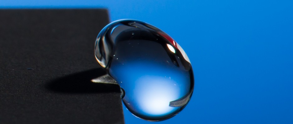 Professor Chunlei Guo has developed a technique that uses lasers to render materials hydrophobic, illustrated in this image of a water droplet bouncing off a treated sample. Credit:  J. Adam Fenster / University of Rochester
